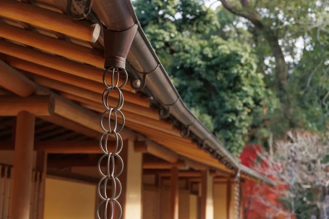 Rain chain in front of traditional house