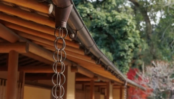 Rain chain in front of traditional house